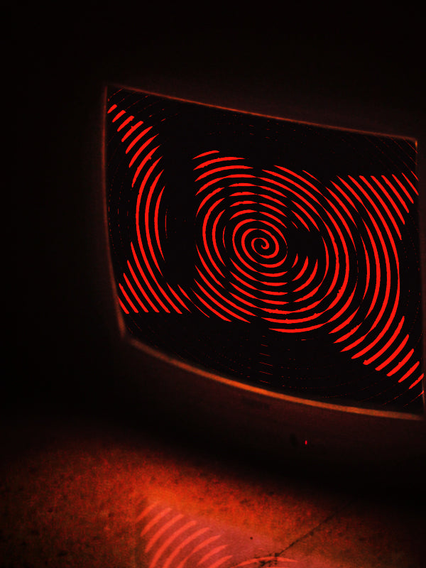 TV glowing red in the dark displaying the word 'LOCO'